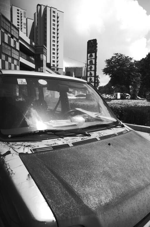A car is parked on the sidewalk. How long has the car been used?